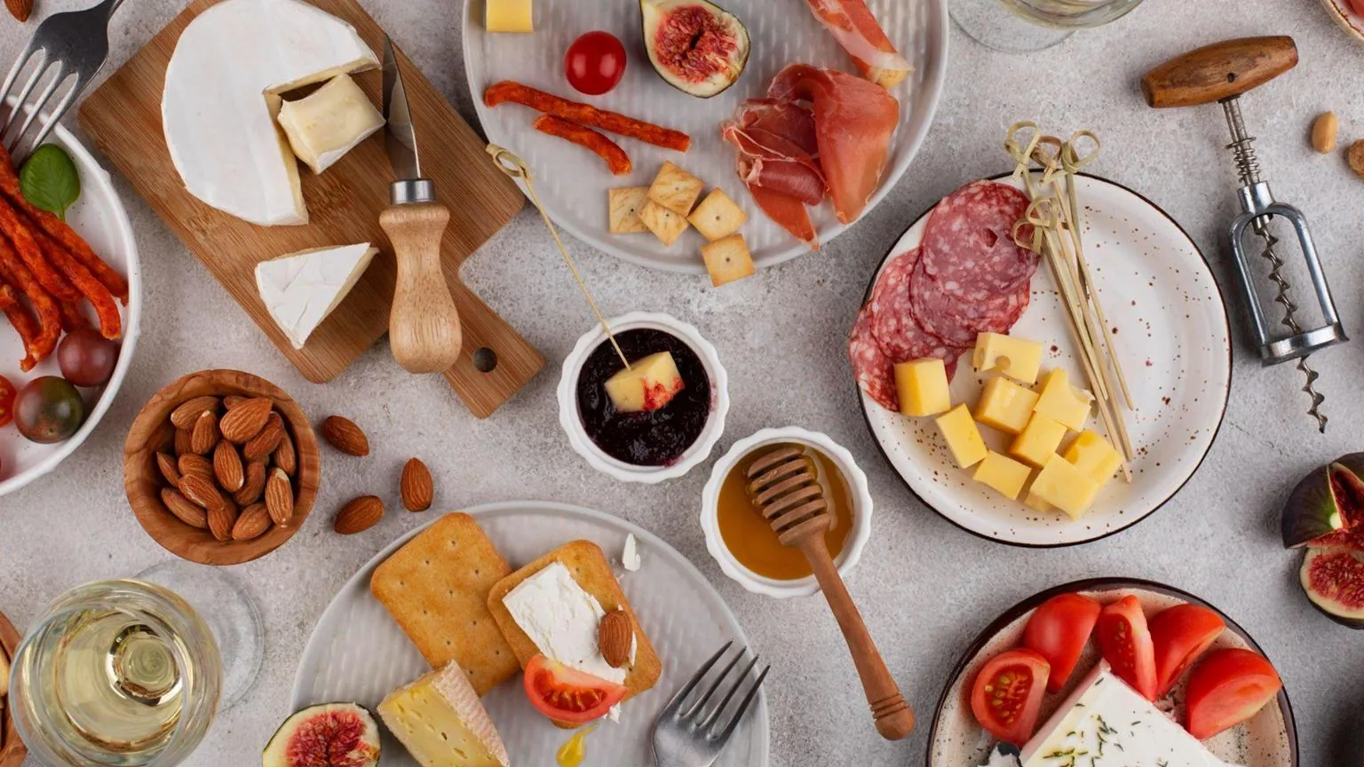 Cheese board with figs, almonds and fresh tomatoes